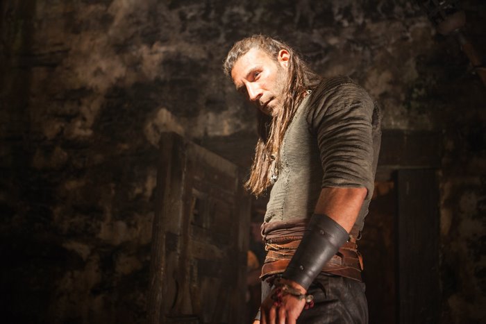 Zach McGowan in a dimly lit room