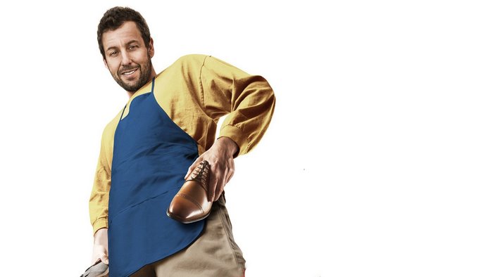 Adam Sandler wearing an apron holding a shoe