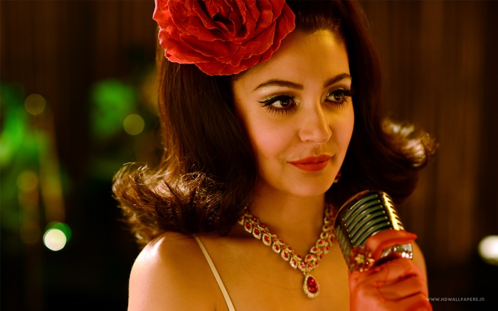 Anushka Sharma singing into a microphone