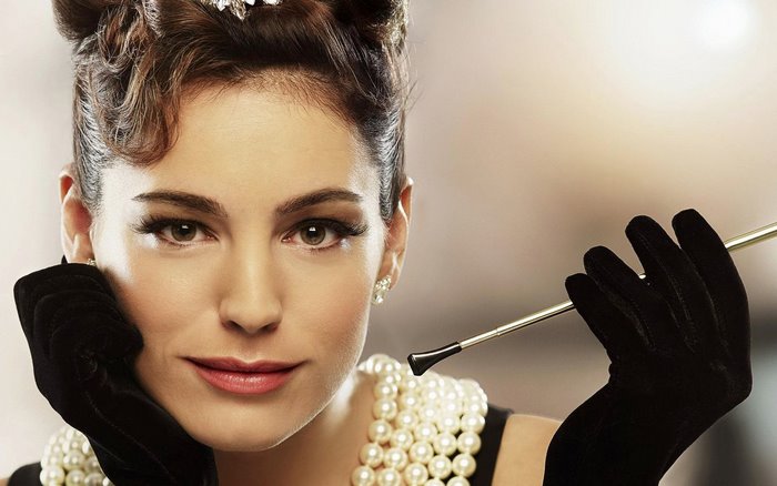 Kelly Brook in vintage attire with cigarette holder