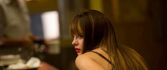 Woman with red lipstick looking over shoulder