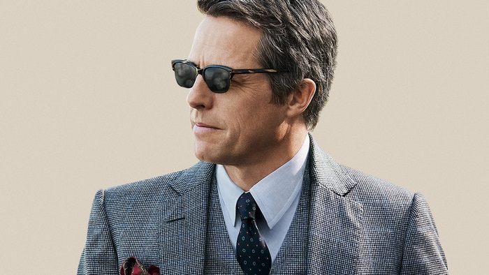 Hugh Grant wearing sunglasses and a suit