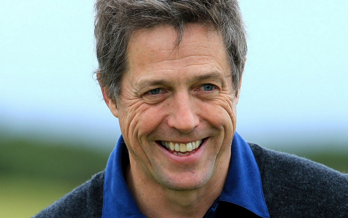 Hugh Grant smiling outdoors