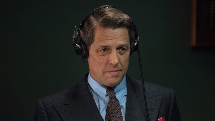 Hugh Grant wearing headphones