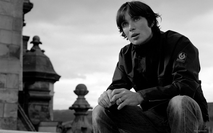 Cillian Murphy sitting on a rooftop
