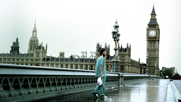 Cillian Murphy walking across Westminster Bridge, London