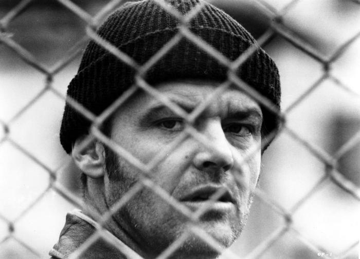 Jack Nicholson behind a chain-link fence
