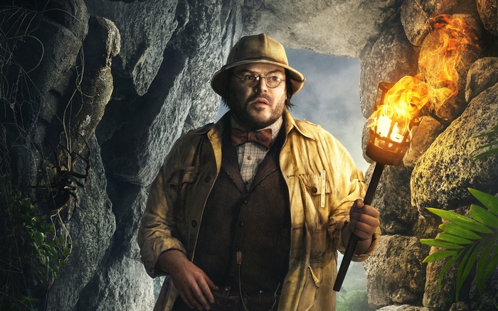 Jack Black in a jungle cave holding a torch