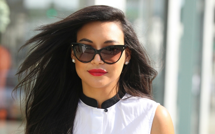 Naya Rivera wearing sunglasses and red lipstick