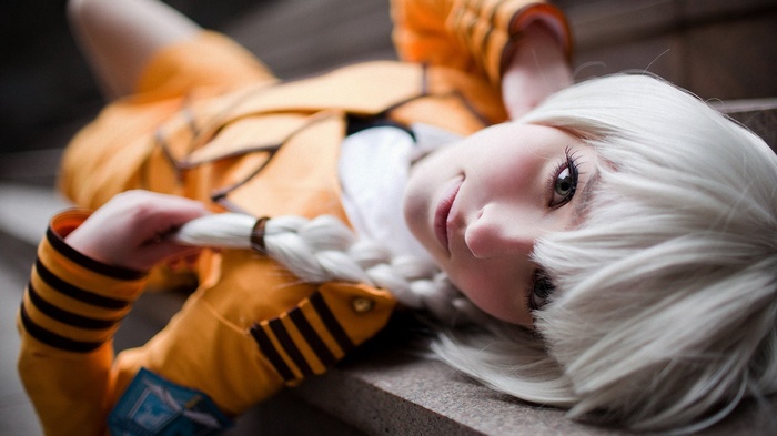 Girl with white hair in orange jacket