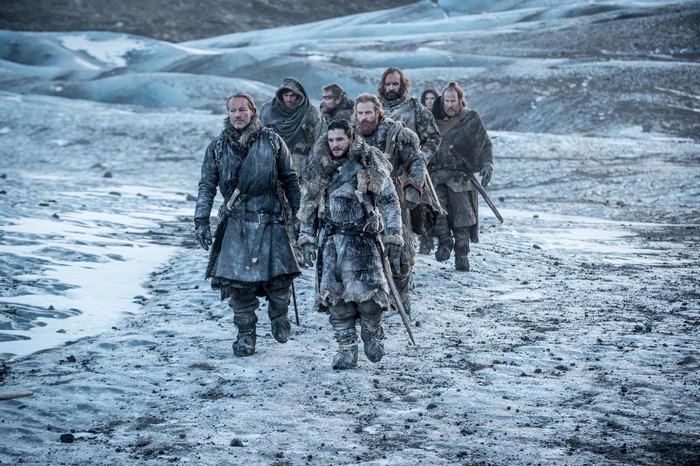 Group of men walking on a glacier