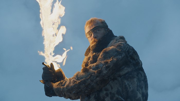 Beric Dondarrion from Game of Thrones holding a flaming sword