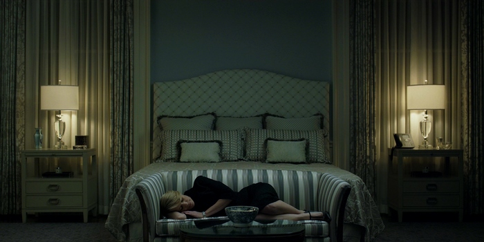 Robin Wright sleeping on a couch in a bedroom