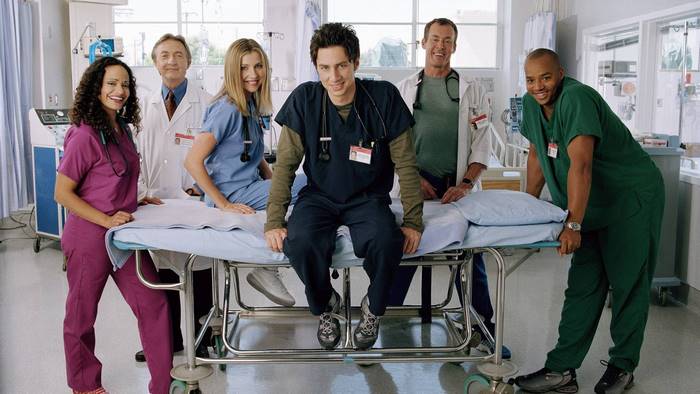 Scrubs cast on a gurney
