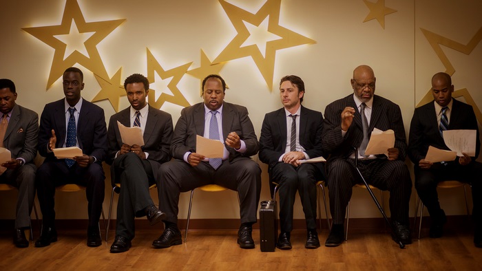 Men in Suits Waiting in a Room with Stars