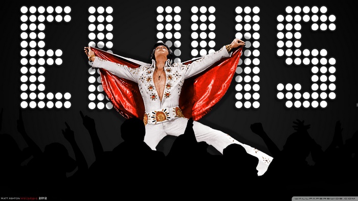 Elvis Presley performing on stage with lights
