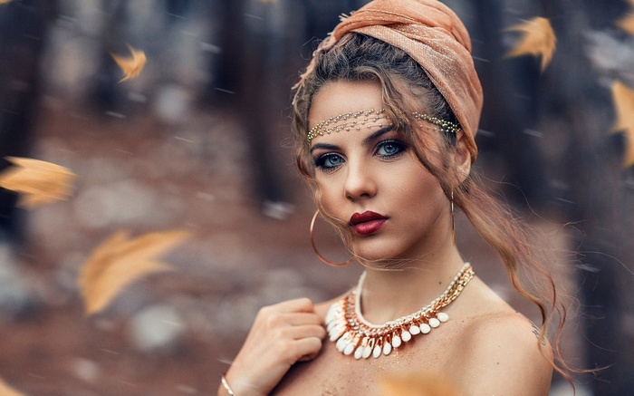 Woman with headscarf and jewelry in autumn
