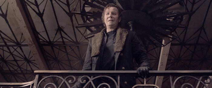 Gary Oldman in a dark, industrial setting