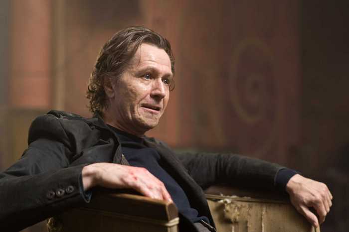 Gary Oldman in a dark room