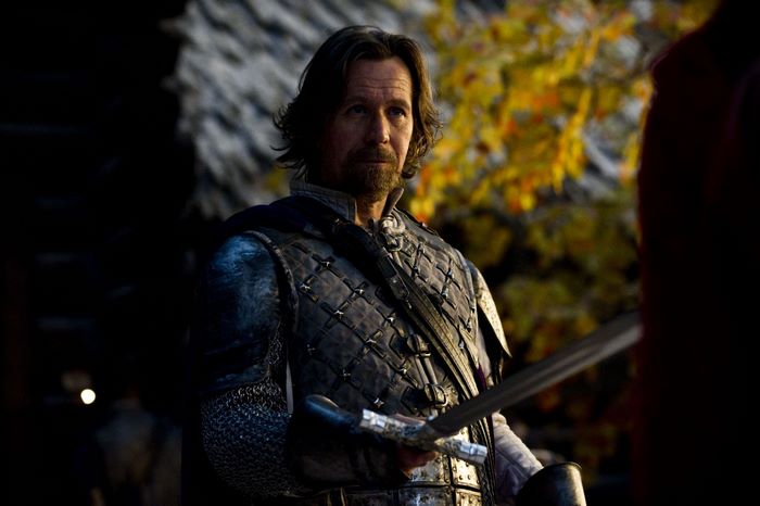 Gary Oldman as a knight with a sword