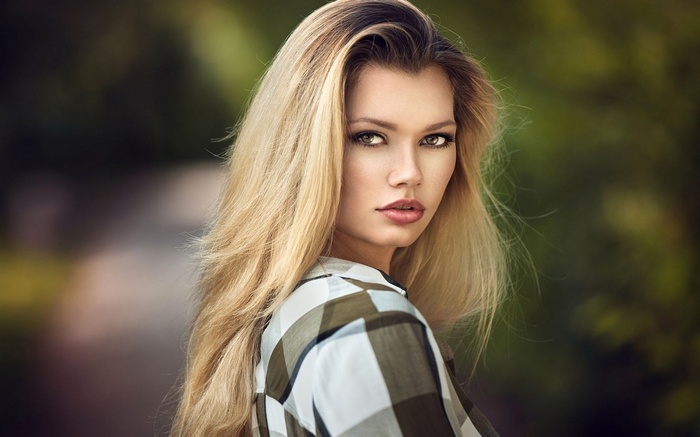 Woman with blonde hair wearing a plaid shirt