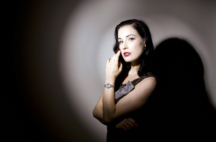 Dita Von Teese posing in dramatic lighting