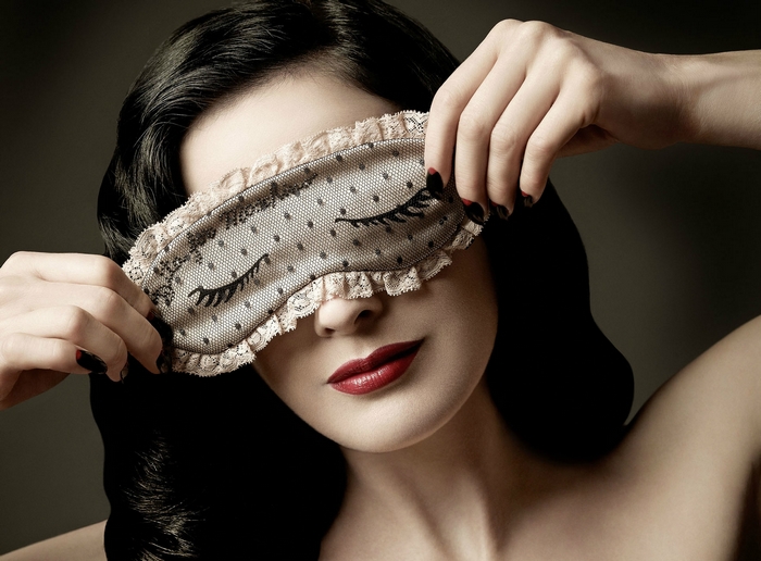 Dita Von Teese wearing a lace sleep mask