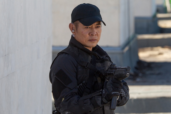Jet Li in tactical gear holding a firearm