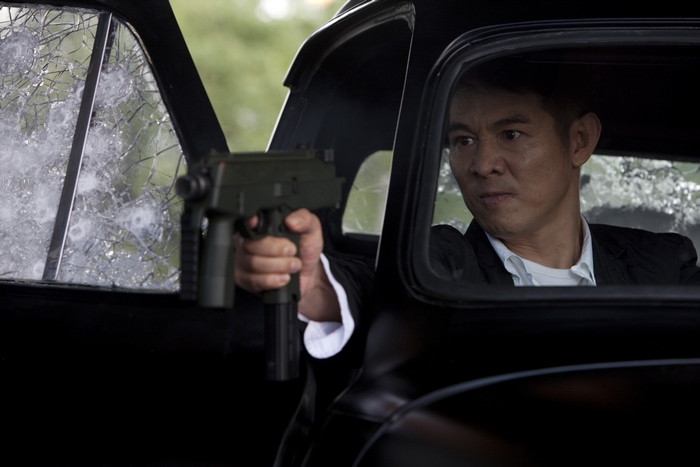 Jet Li in a car holding a gun