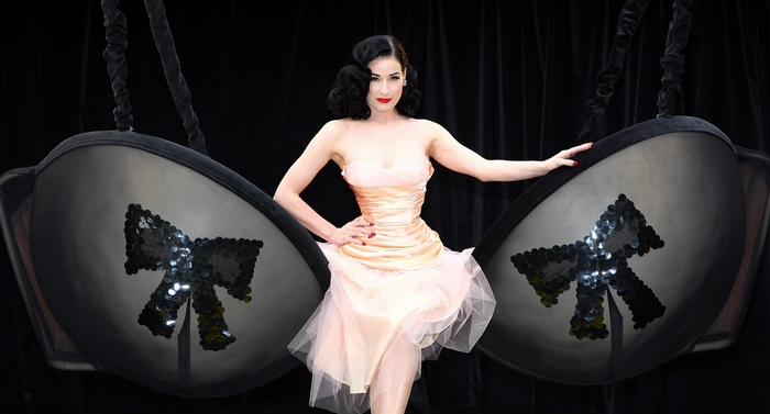Dita Von Teese posing with giant bra