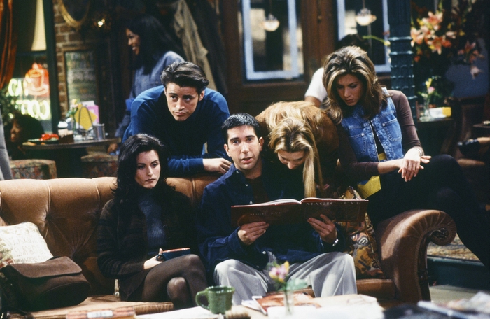 Friends: Ross Geller reading a book with cast