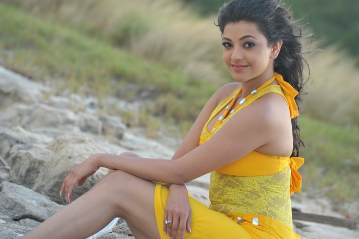 Kajal Agarwal sitting on rocks