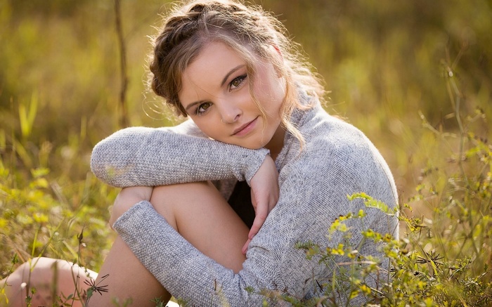Young woman with braided hair in a field