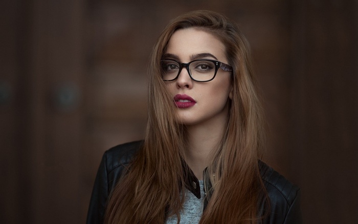 Woman with glasses and dark jacket