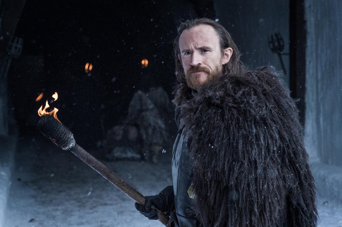 Ben Crompton holding a torch in the snow