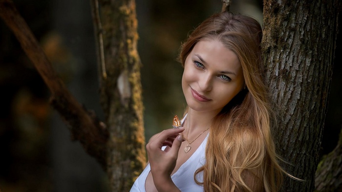 Woman with a butterfly on her finger