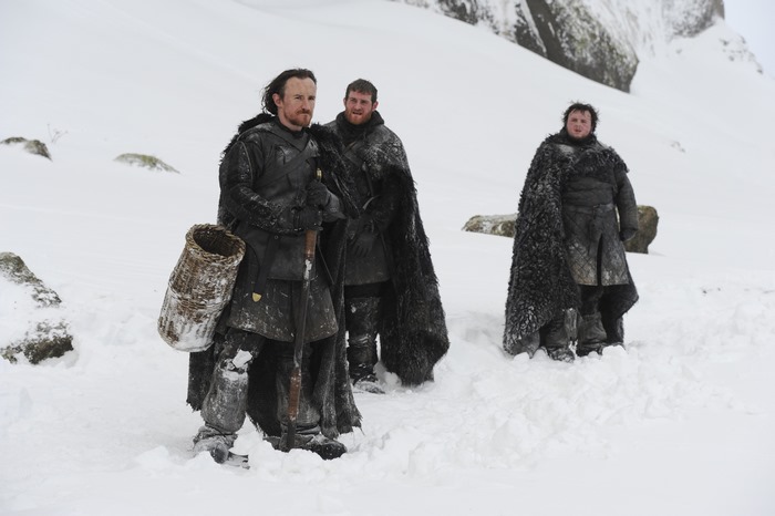 Three men in snow with fur cloaks