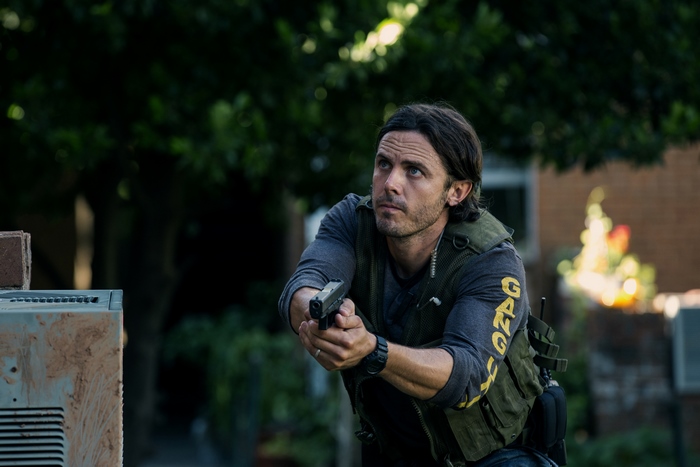 Casey Affleck holding a gun