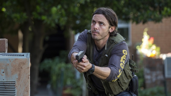 Casey Affleck holding a gun