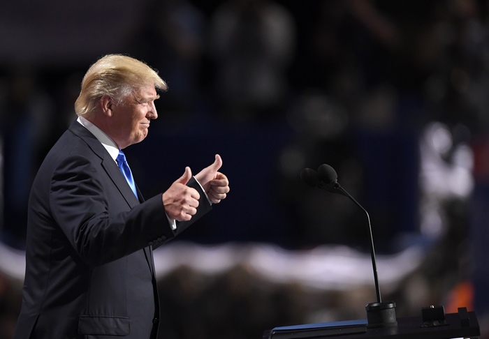 Donald Trump giving thumbs up at podium