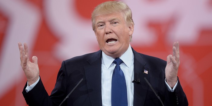Donald Trump speaking at a podium