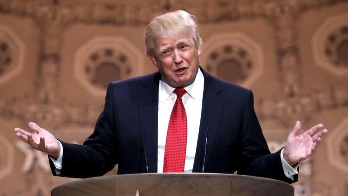 Donald Trump speaking at a podium