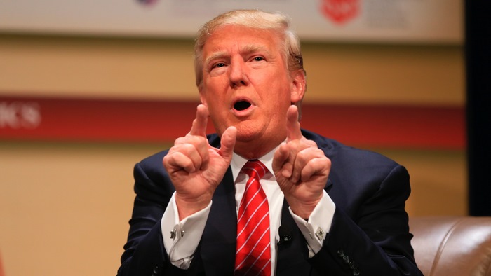 Donald Trump speaking at a podium