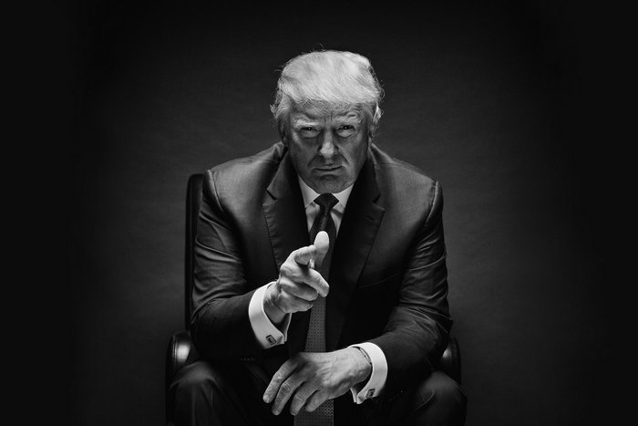 Donald Trump sitting and pointing