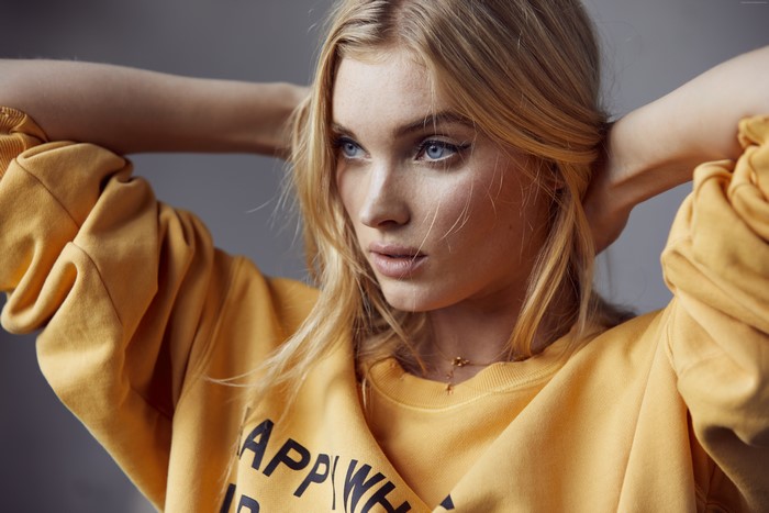 Elsa Hosk wearing a yellow sweatshirt