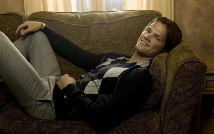 Jared Padalecki relaxing on a couch