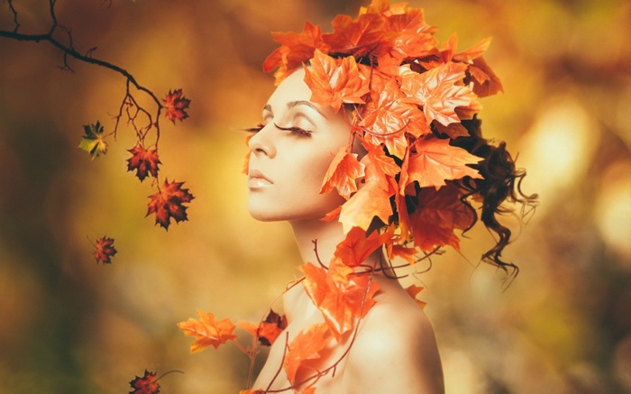 Woman with autumn leaves in her hair