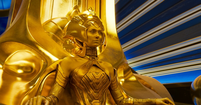 Elizabeth Debicki as Ayesha on a golden throne