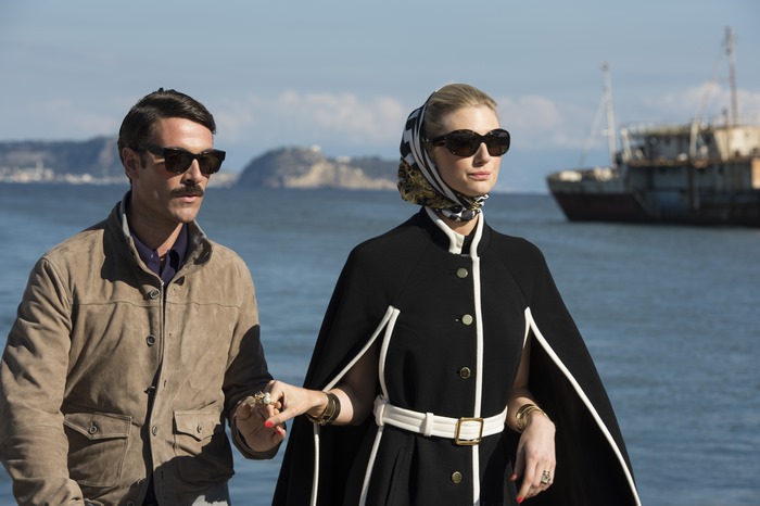 Elizabeth Debicki and man by the sea
