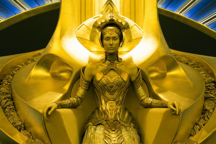 Elizabeth Debicki as Ayesha on a golden throne